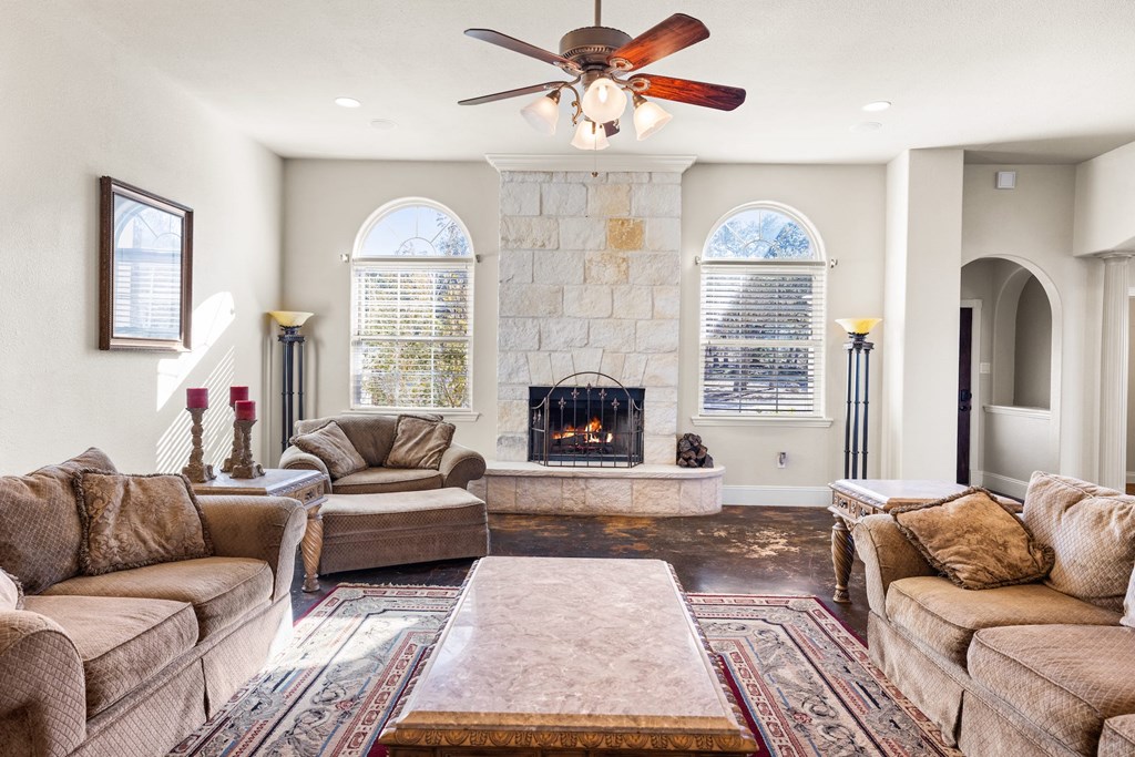 157 McCullough Ranch Road Kerrville, TX 78028 - Photo 32 of 75 a living room with furniture and a fireplace