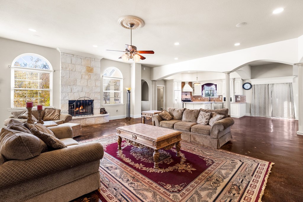 157 McCullough Ranch Road Kerrville, TX 78028 - Photo 33 of 75 a living room with furniture a chandelier and a rug