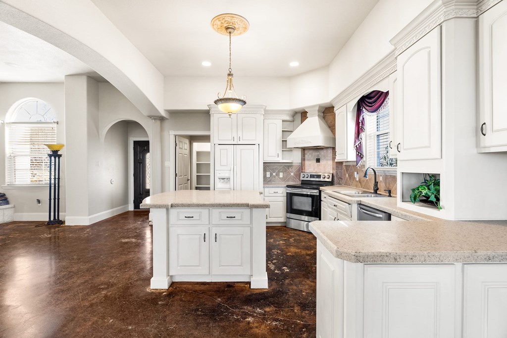 157 McCullough Ranch Road Kerrville, TX 78028 - Photo 36 of 75 a kitchen with granite countertop a sink cabinets and window