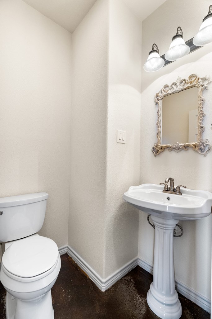 157 McCullough Ranch Road Kerrville, TX 78028 - Photo 39 of 75 a bathroom with a sink a toilet and mirror