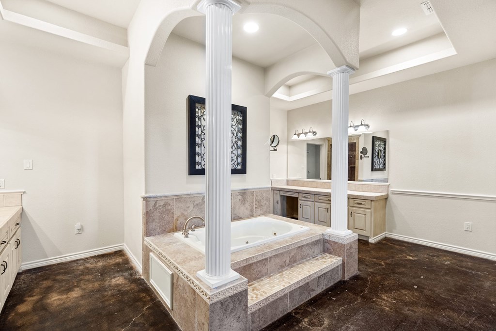 157 McCullough Ranch Road Kerrville, TX 78028 - Photo 43 of 75 a spacious bedroom with a bed and a cabinets