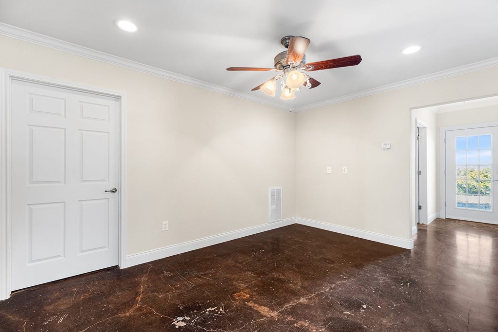 157 McCullough Ranch Road Kerrville, TX 78028 - Photo 48 of 75 an empty room with wooden floor fan and windows