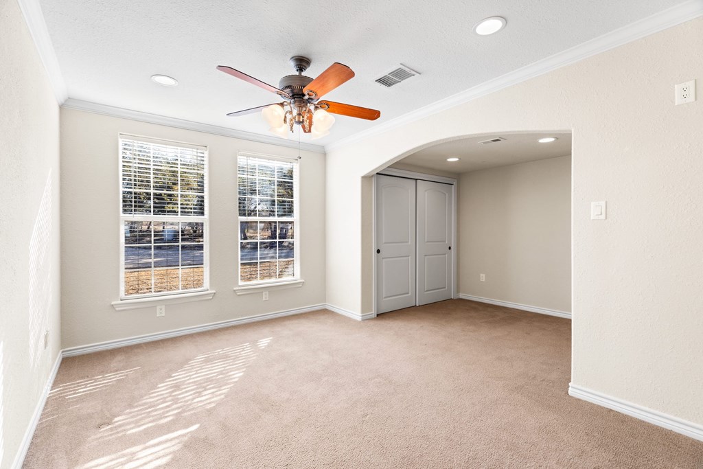 157 McCullough Ranch Road Kerrville, TX 78028 - Photo 49 of 75 an empty room with windows and fan