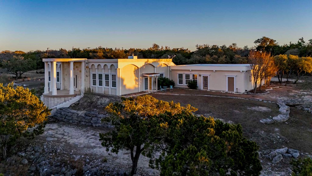 157 McCullough Ranch Road Kerrville, TX 78028 - Photo 56 of 75 a view of a house with backyard and sitting area