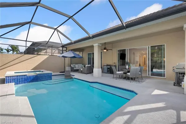 a view of a backyard with furniture and tub
