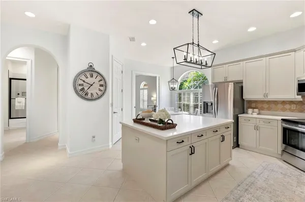 a kitchen with stainless steel appliances a sink stove and refrigerator