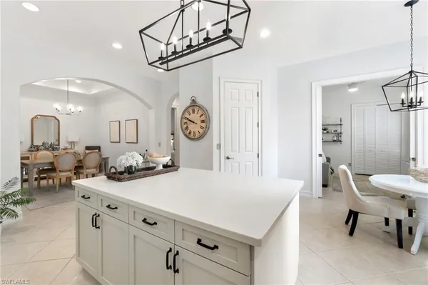 a kitchen with stainless steel appliances granite countertop a stove and a clock on the wall
