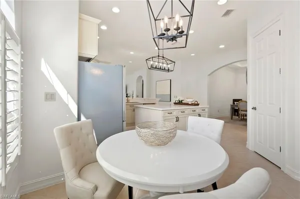 a view of a dining room with furniture and chandelier