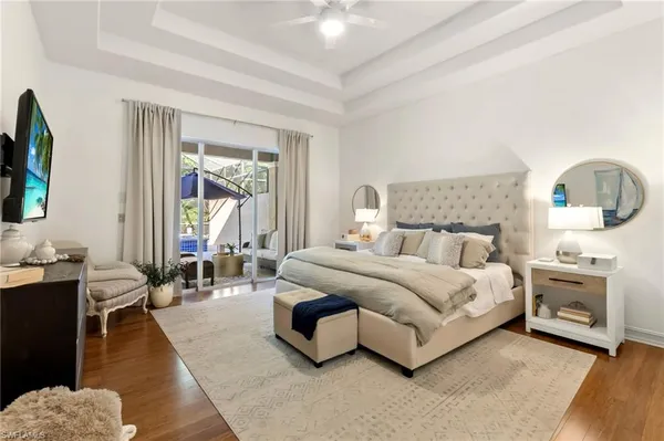 a dining room with furniture a chandelier and wooden floor