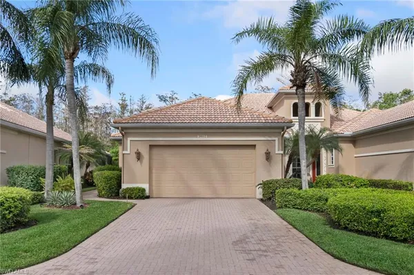 a front view of house with a garden