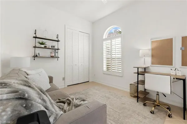 a living room with furniture and a dining table