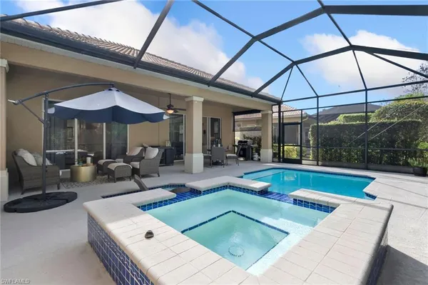 a view of a patio with a table and chairs under an umbrella