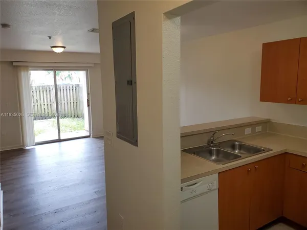 a room that has a sink and a wooden floor