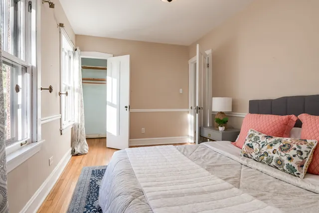 a bedroom with a large bed and a chandelier