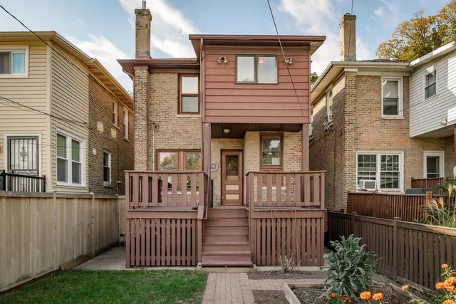 a view of a house with wooden fence