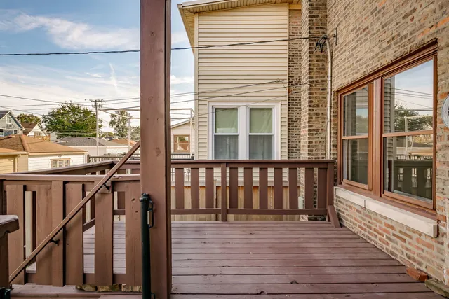 a view of a balcony with wooden floor and furniture