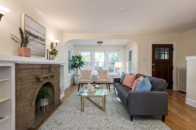 a living room with furniture and a fireplace