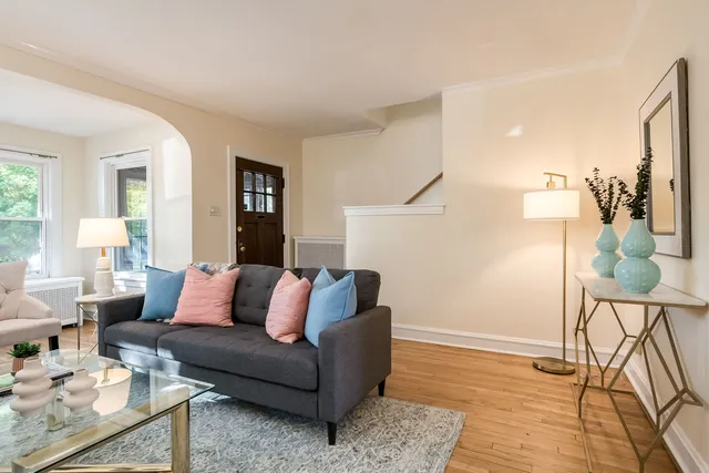 a living room with furniture and a wooden floor