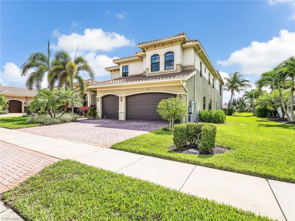 2756 Crystal Way Naples, FL 34119 - Photo 3 of 50 a front view of a house with a yard