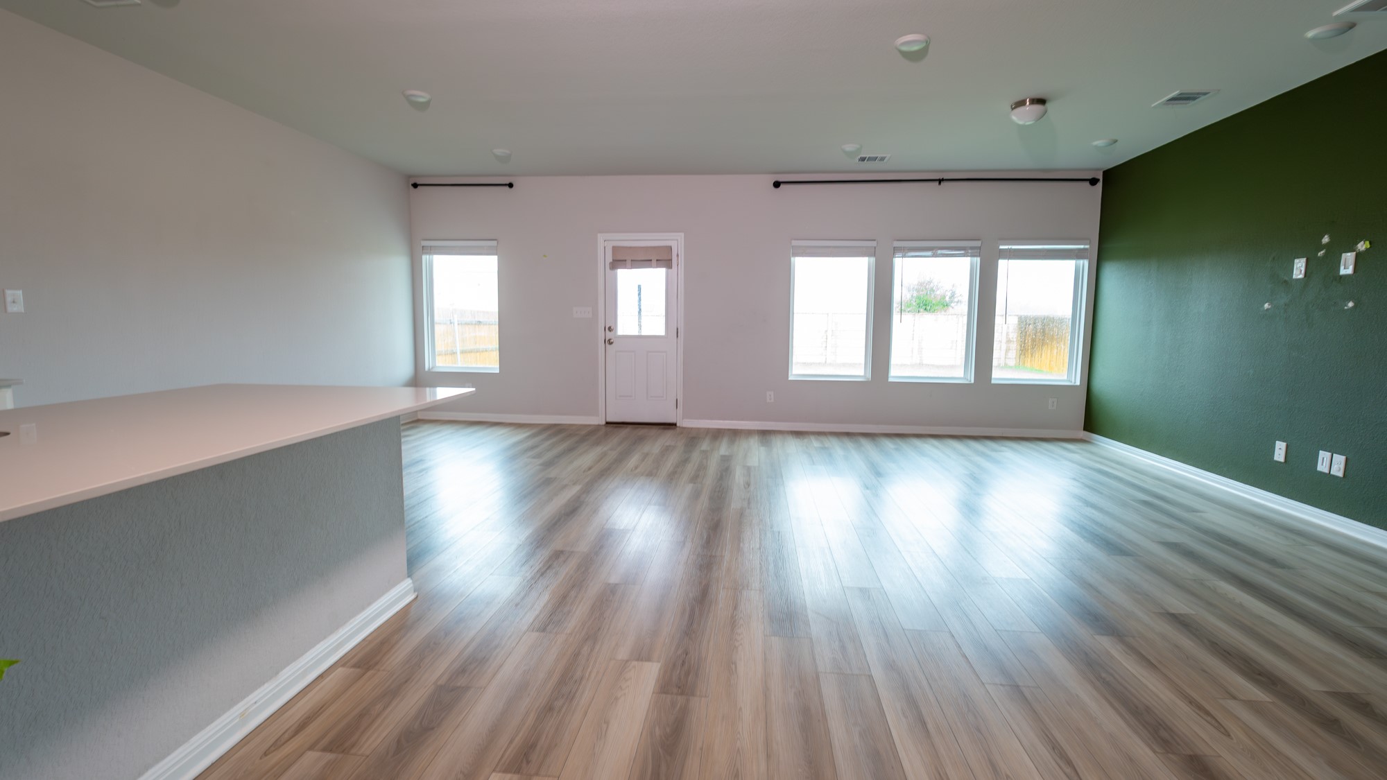 13108 Chapala Way Manor Manor, TX 78653 - Photo 4 of 36 an empty room with wooden floor and windows