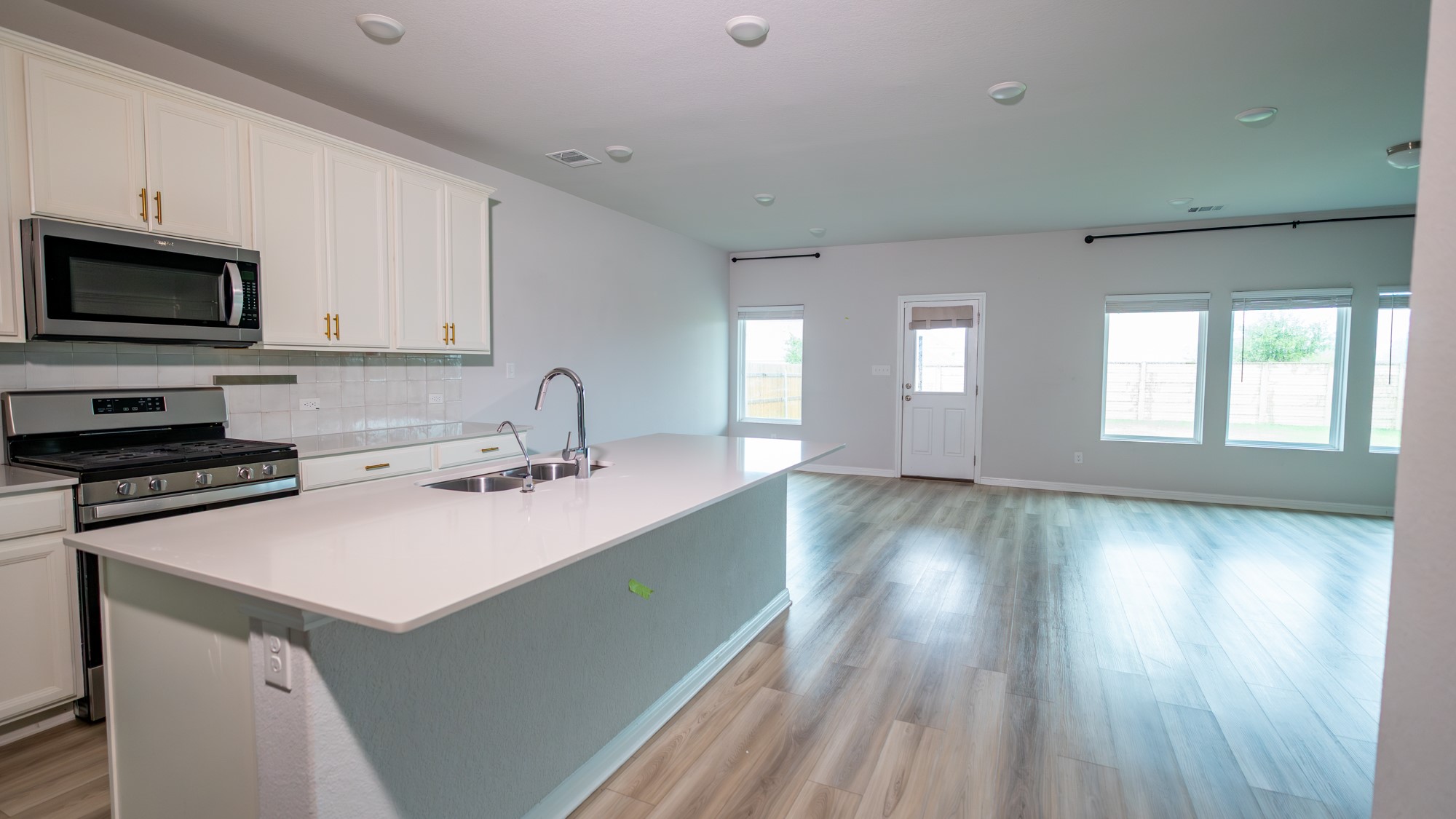 13108 Chapala Way Manor Manor, TX 78653 - Photo 6 of 36 a kitchen with a sink stove and cabinets