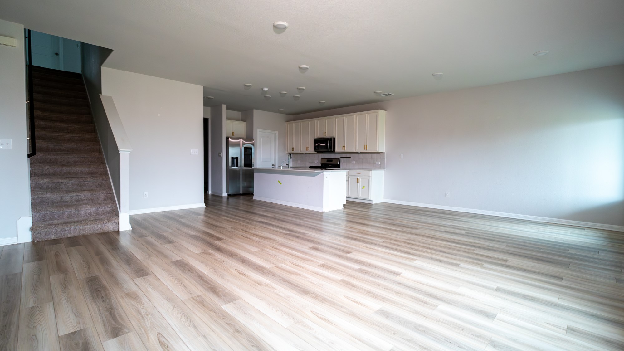 13108 Chapala Way Manor Manor, TX 78653 - Photo 10 of 36 a view of a kitchen with wooden floor and electronic appliances