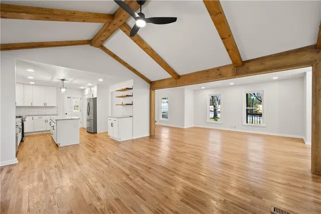 a view of empty room with wooden floor