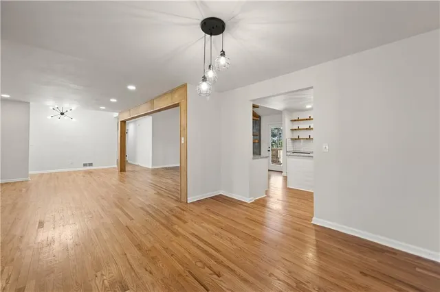 a view of a room with wooden floor and window