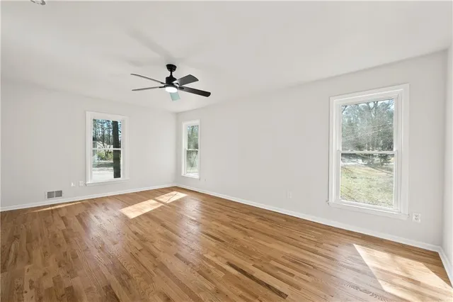 wooden floor in an empty room with a window