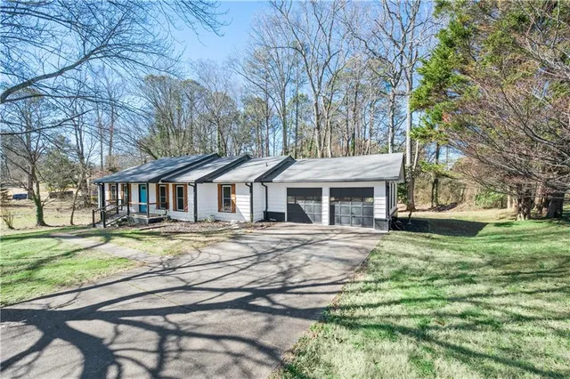 a view of a house with a yard and sitting area