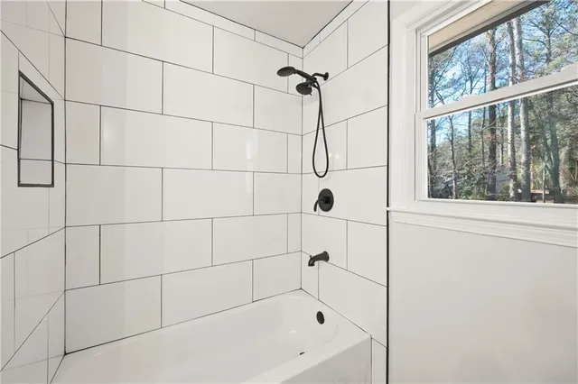 a bathroom with a bathtub and a shower