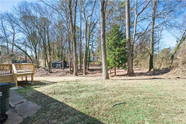 a view of a yard with large trees