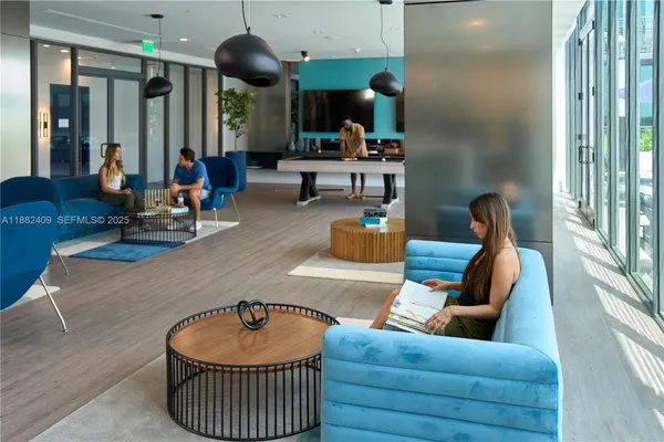 a view of a chairs and table in patio with a yard
