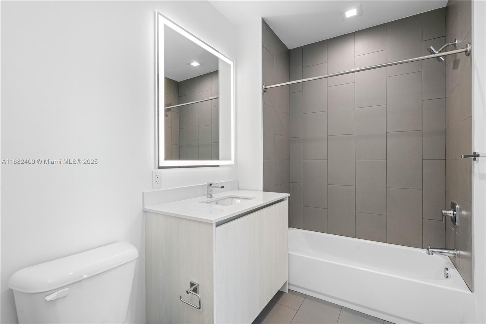 1809 Jackson Street, Unit 709 Hollywood, FL 33020 - Photo 22 of 40 a bathroom with a sink a toilet and shower