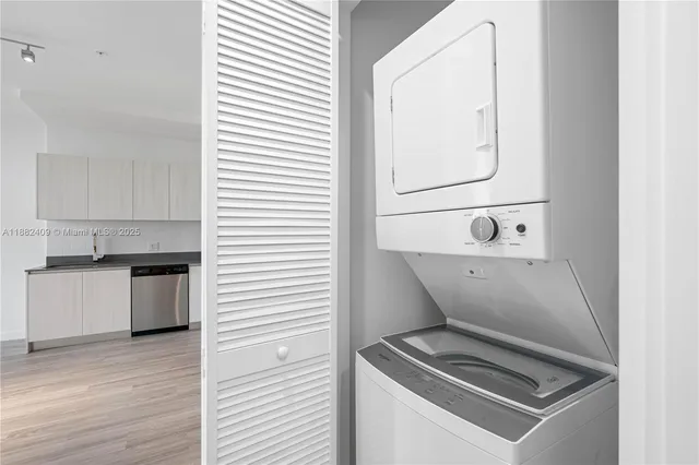 a kitchen with granite countertop white cabinets and stainless steel appliances