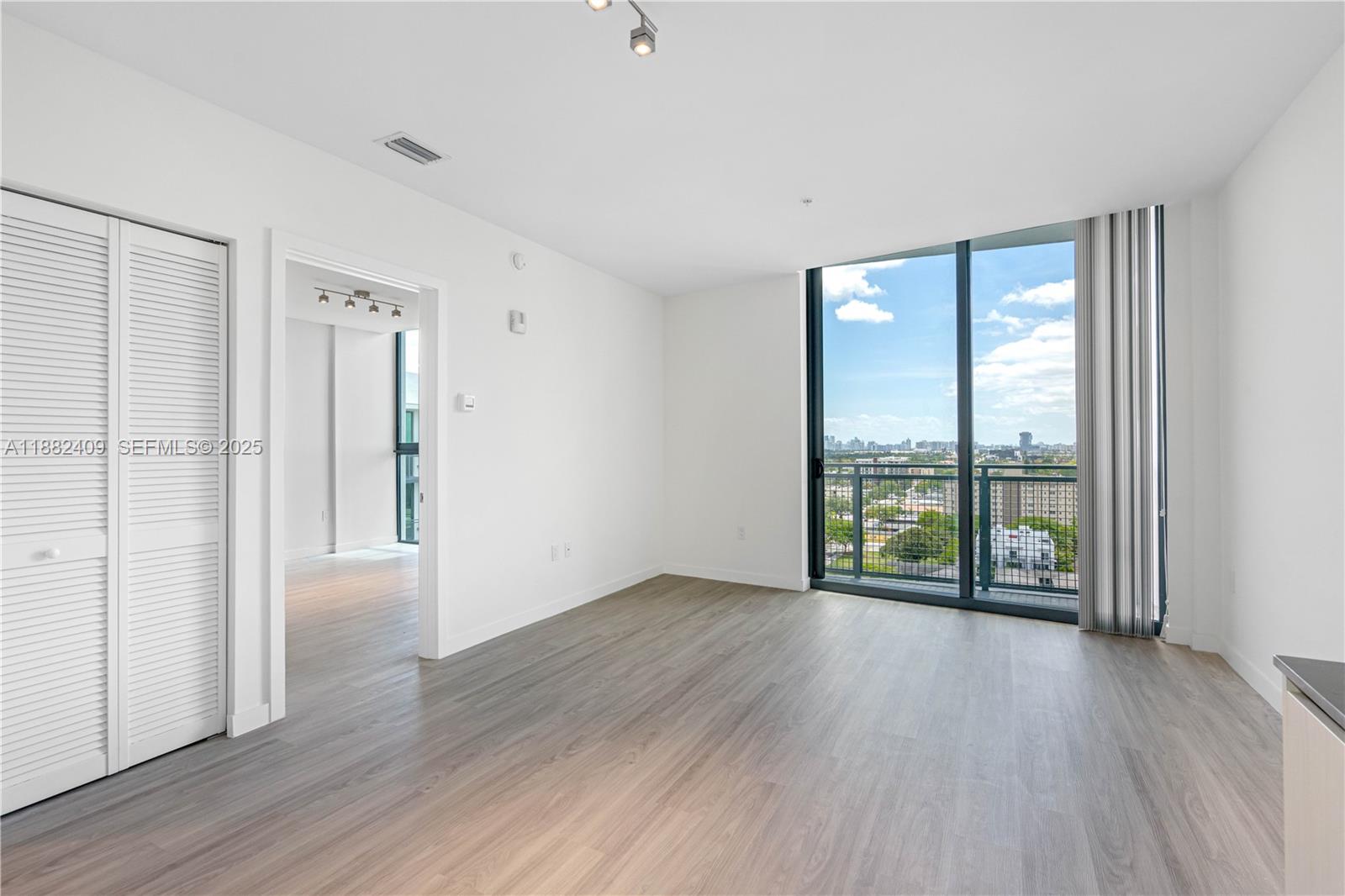 1809 Jackson Street, Unit 709 Hollywood, FL 33020 - Photo 24 of 40 an empty room with wooden floor and windows
