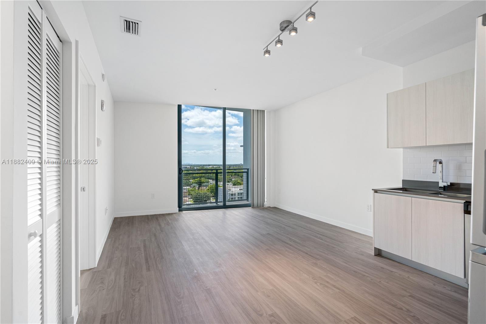 1809 Jackson Street, Unit 709 Hollywood, FL 33020 - Photo 25 of 40 wooden floor in an empty room with a window