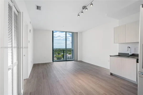 a kitchen with stainless steel appliances a refrigerator and a stove top oven