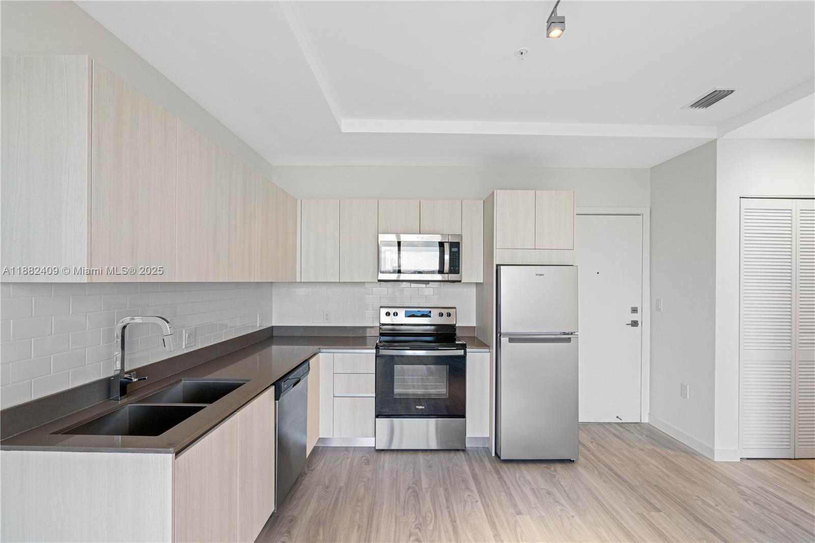 1809 Jackson Street, Unit 709 Hollywood, FL 33020 - Photo 27 of 40 a kitchen with a sink a stove and refrigerator