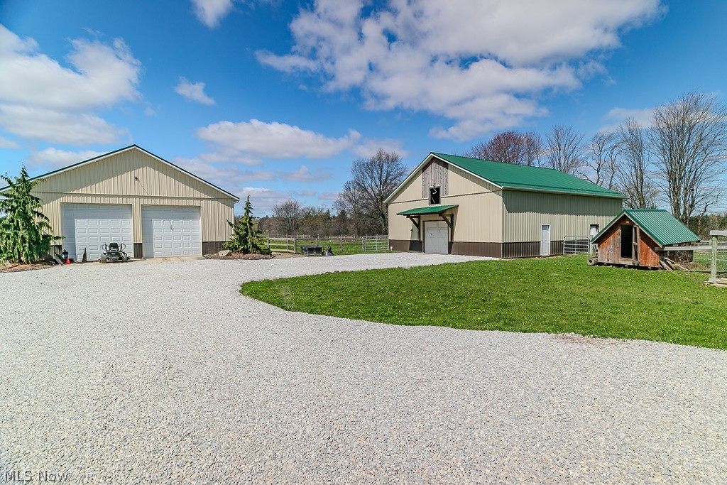 18919 Ravenna Road Chagrin Falls, OH 44023 - Photo 32 of 48 70'x40' Pole Barn with 2 overhead doors on the left and 48'x40' 4-stall barn with room for additional stalls on the right.