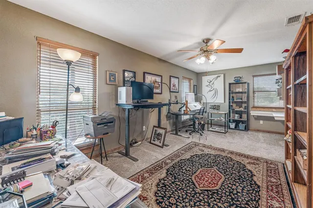 a dining table with chairs and cabinets