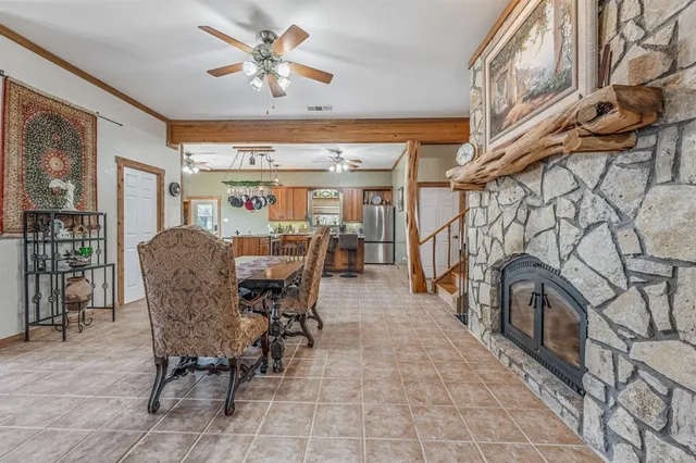 a view of a livingroom with furniture and a dining table chairs