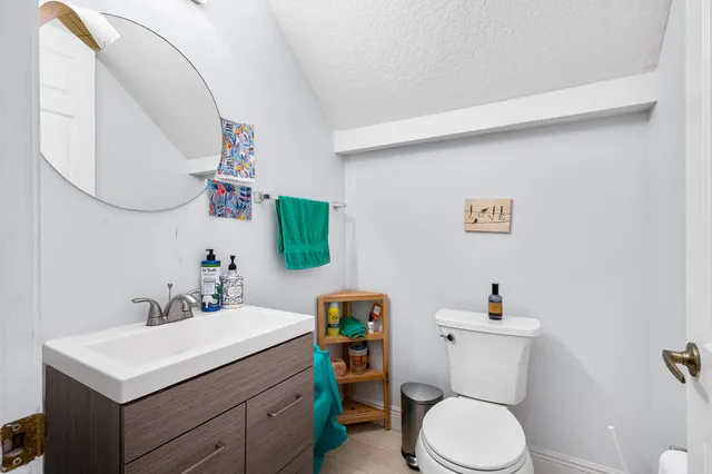 a bathroom with a toilet sink and mirror