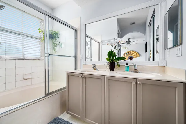 a bathroom with a sink a mirror and a shower