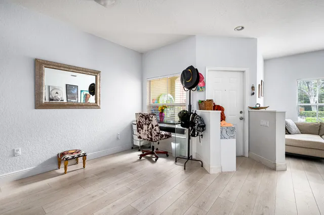 a view of a livingroom with workspace and a window