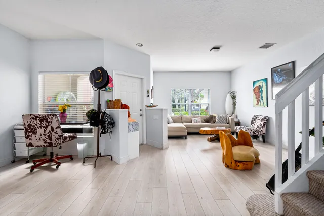 a bedroom with furniture and a wooden floor
