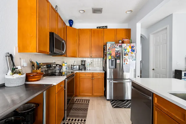 a kitchen with a refrigerator and a sink