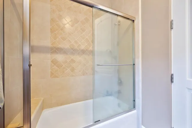 an aerial view of a house with a yard and large trees