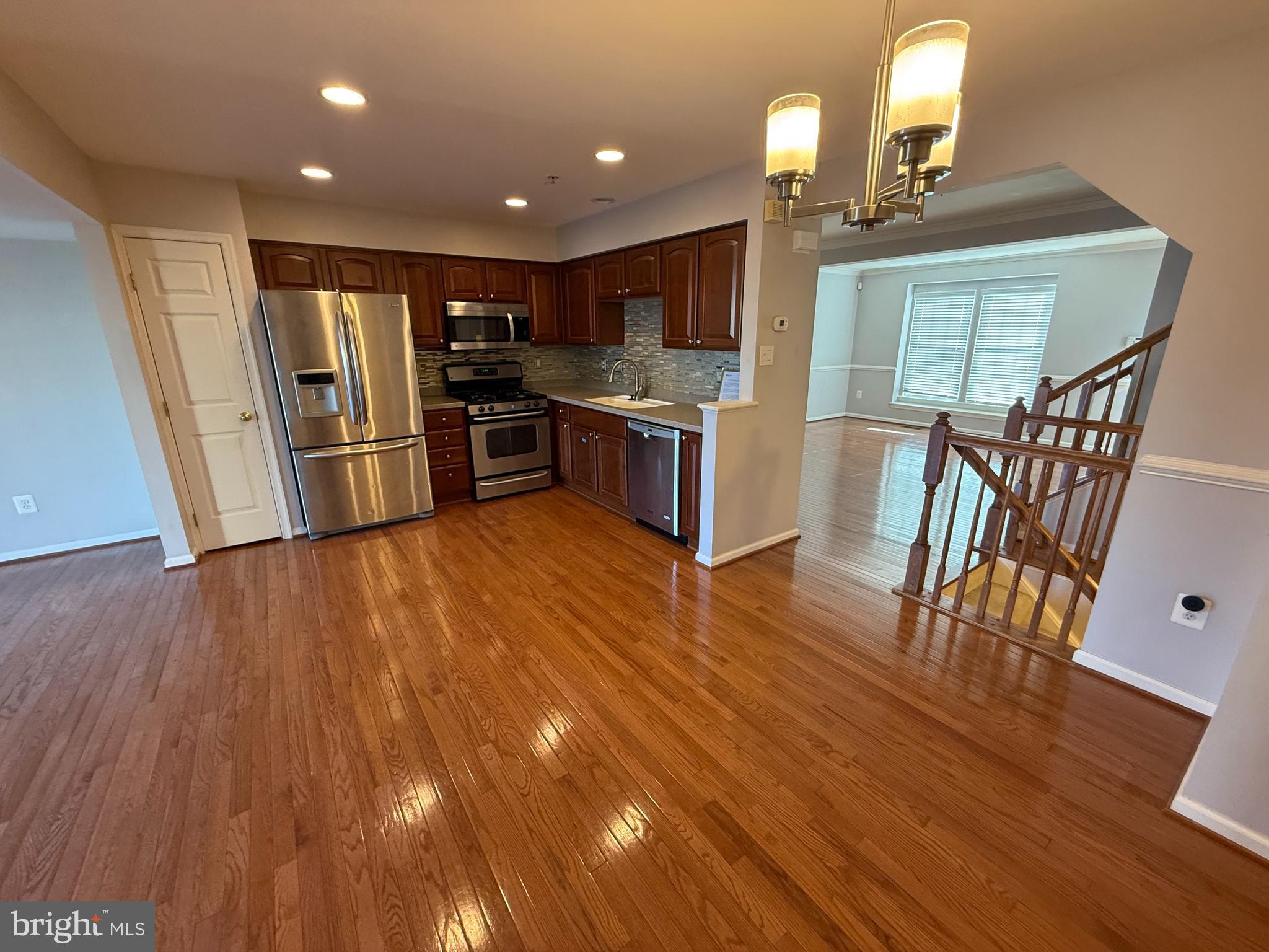 7088 Maiden Point Place, Unit 25 Elkridge, MD 21075 - Photo 4 of 16 a open kitchen with stainless steel appliances wooden floors stove and wooden floors