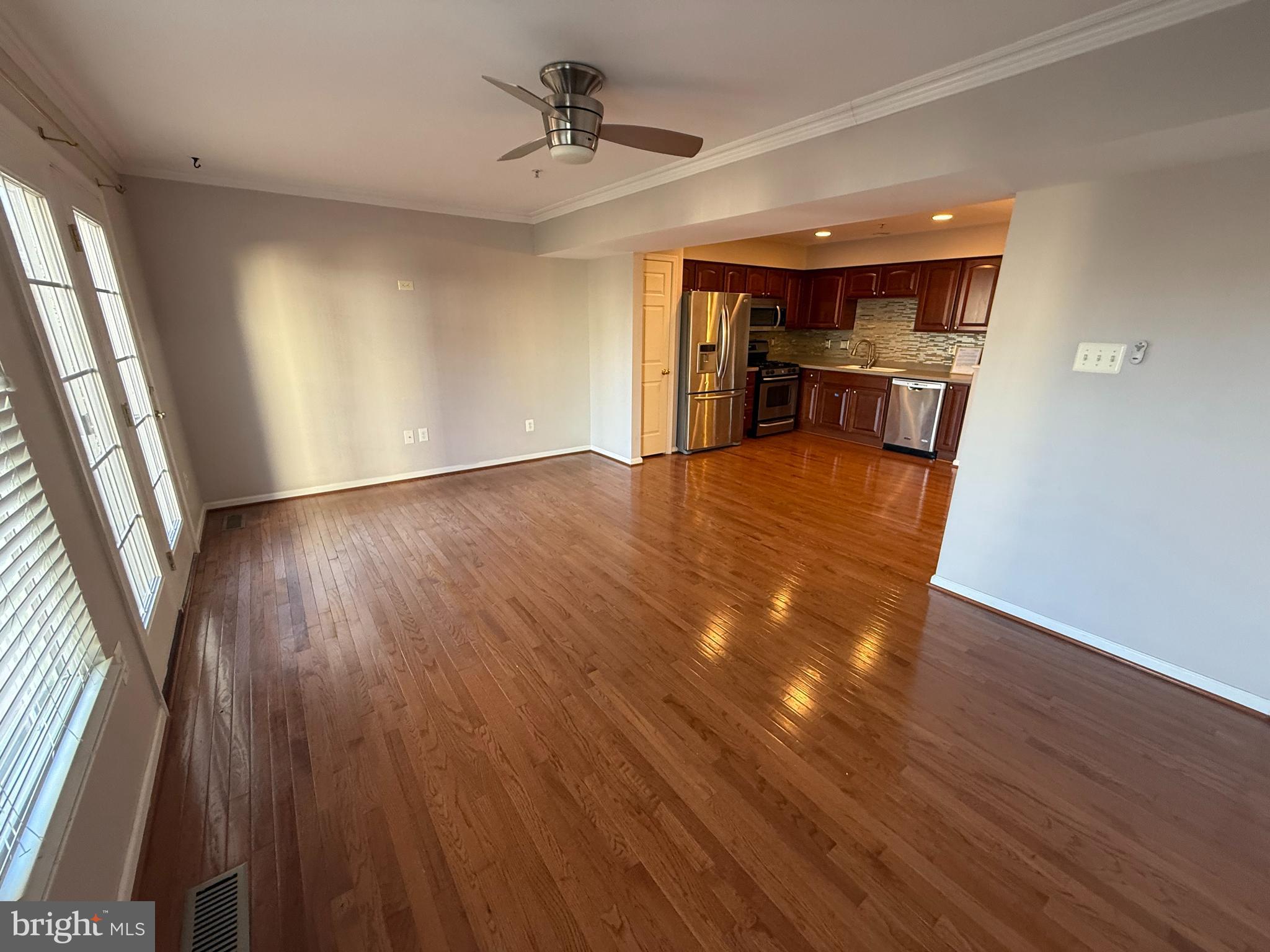 7088 Maiden Point Place, Unit 25 Elkridge, MD 21075 - Photo 5 of 16 wooden floor in an empty room with a window